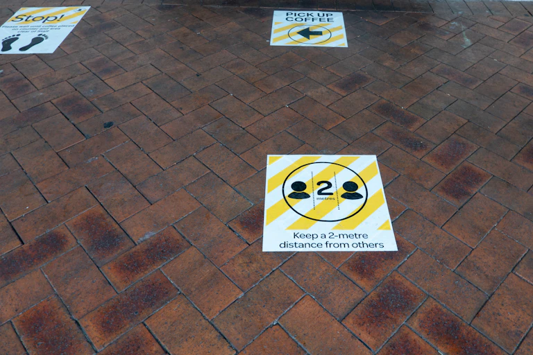 Two-metre social distancing pavement signs