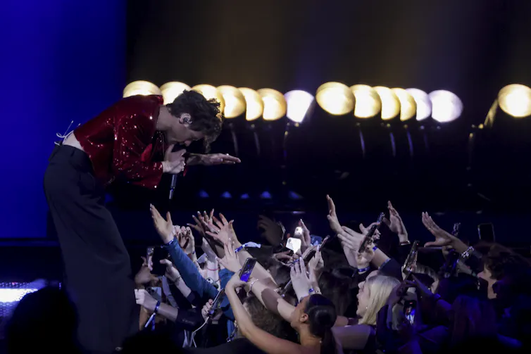 Harry Styles performing for fans