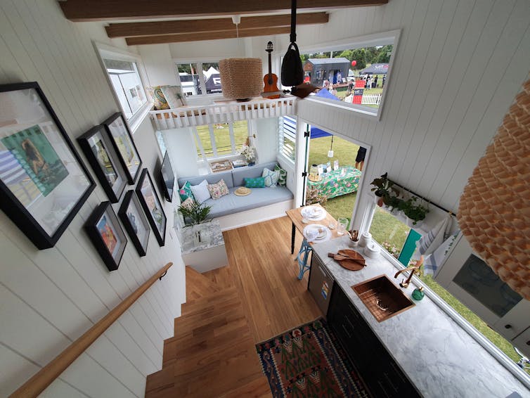 Looking down at the interior of a tiny house from the upper level