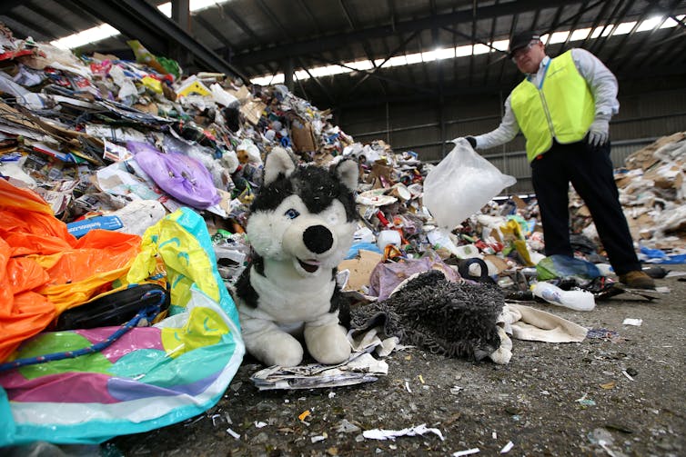 General waste including a soft toy dog and deflated pool toys among recyclable items from kerbside recycling bins at the Cleanaway Recycling Centre in Brisbane
