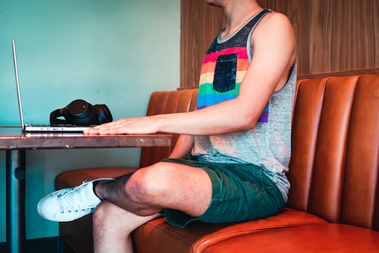 Queer person sits at dinner table
