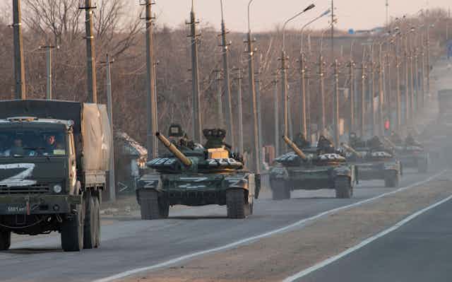 Russian tanks and trucks bearing the character Z as a symbol of victory