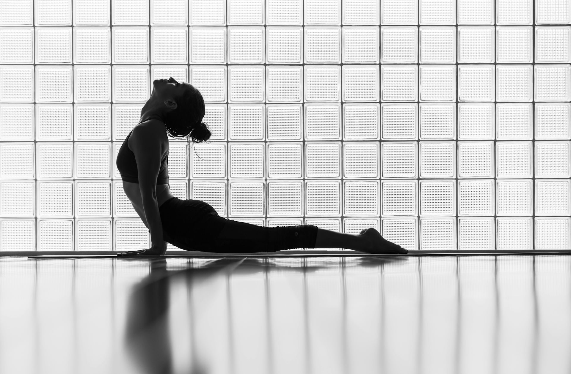 Silhouette of woman doing a yoga pose.