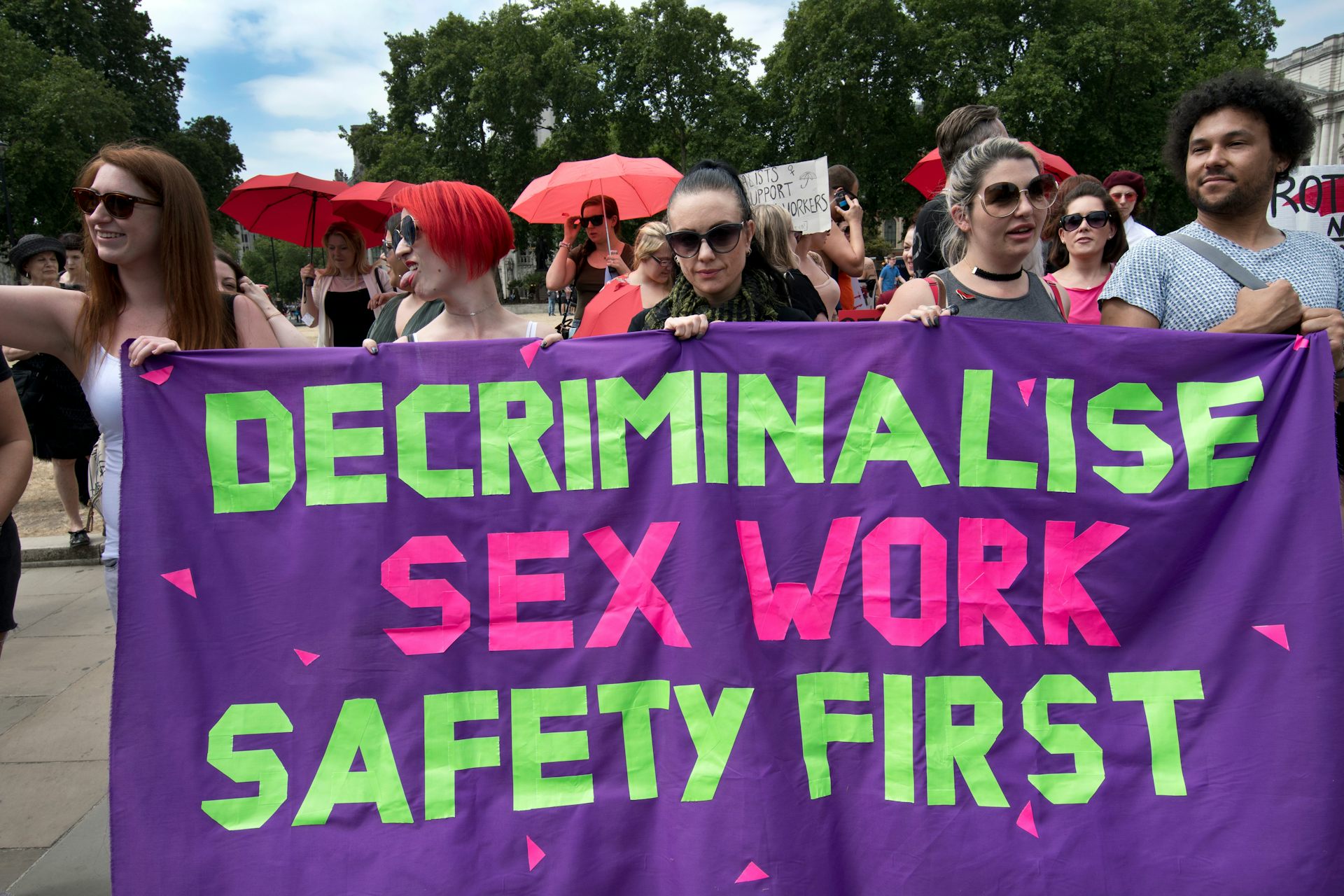 Protestors hold a banner that reads: 'Decriminalise sex work safety first'