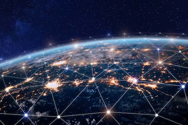 A picture of the Earth covered with a web of glowing dots that are connected by white lines