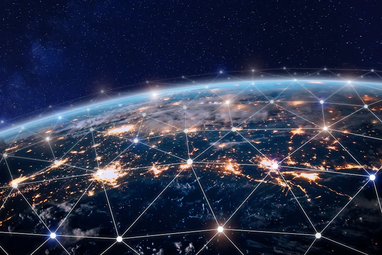 A picture of the Earth covered with a web of glowing dots that are connected by white lines