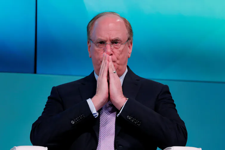 Larry Fink with his hands together
