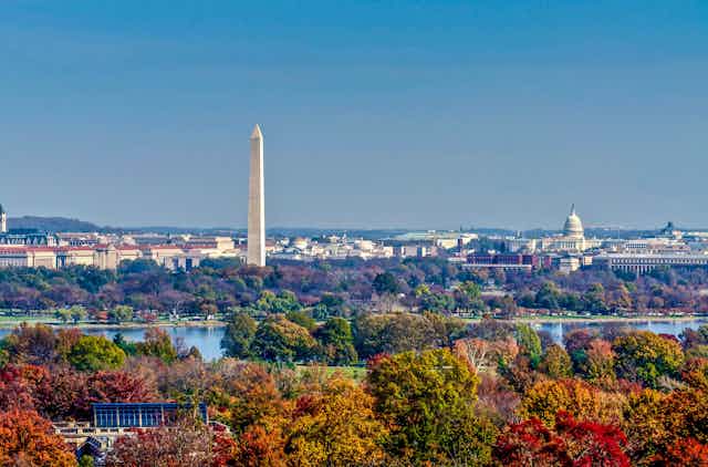 A view of Washington and its river against a backdrop of autumnal trees