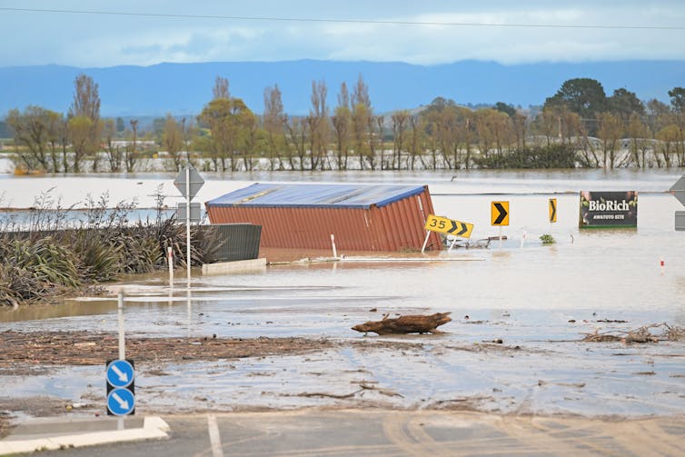 A flooded house, paddock and trees in the Hawke's Bay.