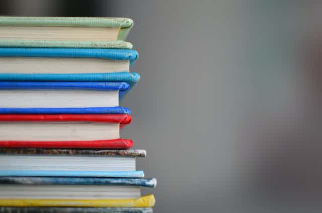 A stack of books with coloured covers.