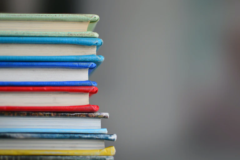 A stack of books with coloured covers.