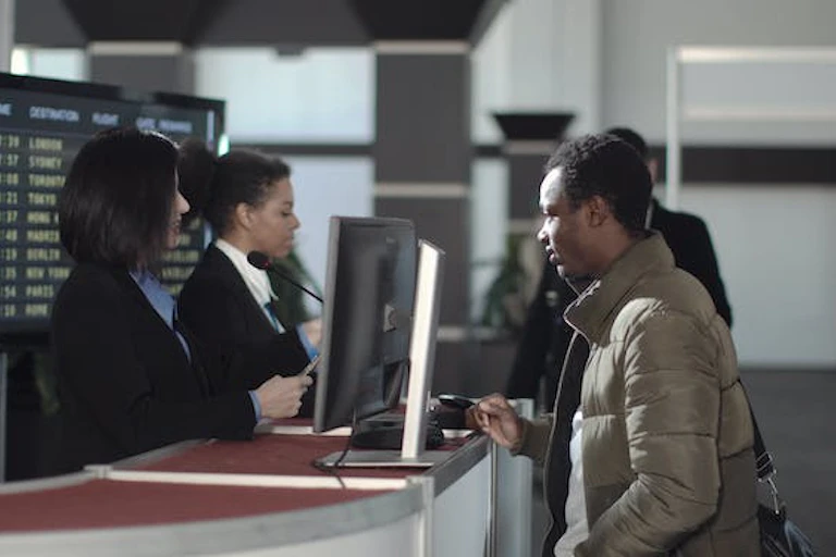 Man standing at the check-in desk at airport