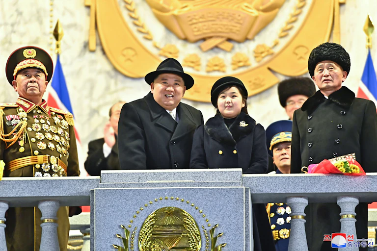 North Korean leader Kim Jong-un and his daughter Kim Ju-ae on a balcony surrounded by senior officials