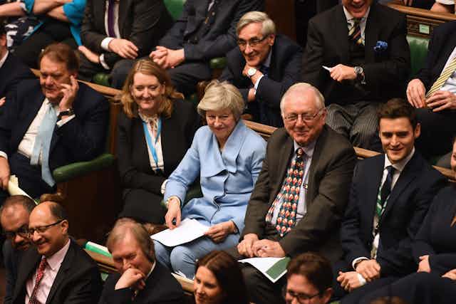 Theresa May sitting in the House of Commons