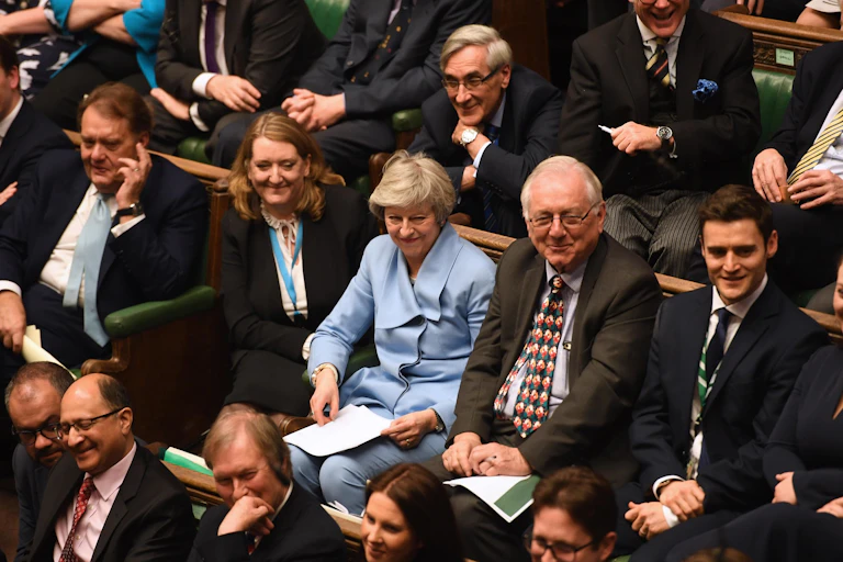 Theresa May sitting in the House of Commons