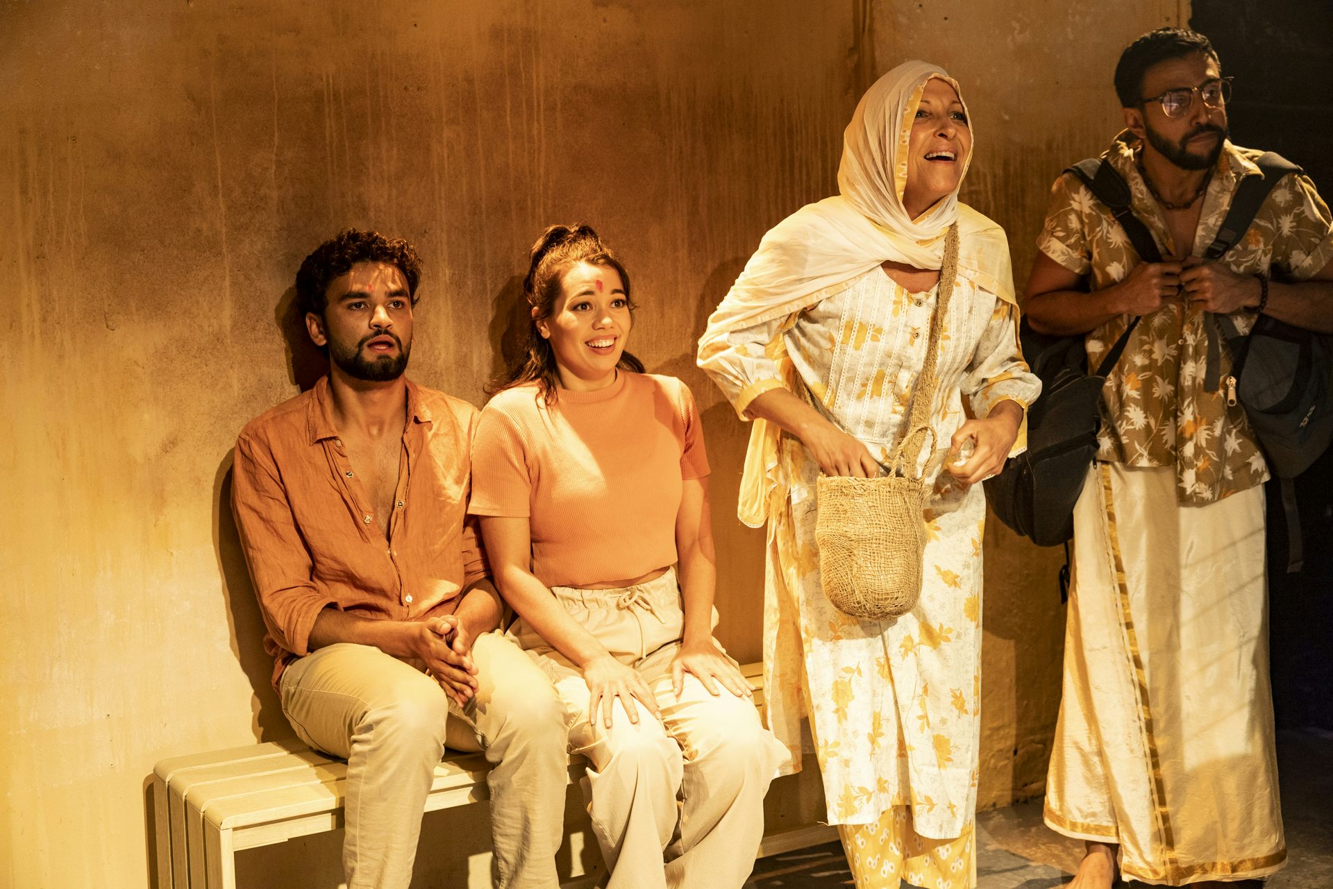 Four people on a yellow stage