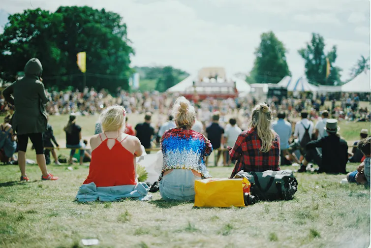Women at a festival at the back of the crowd
