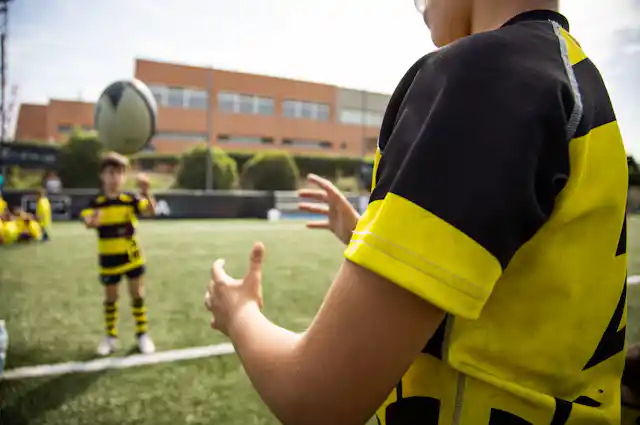 Children throwing rugby ball