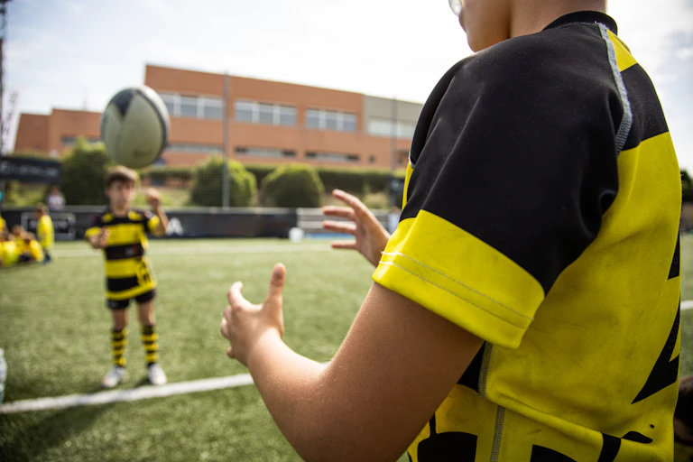 Children throwing rugby ball