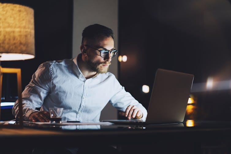 Man checking his email at night