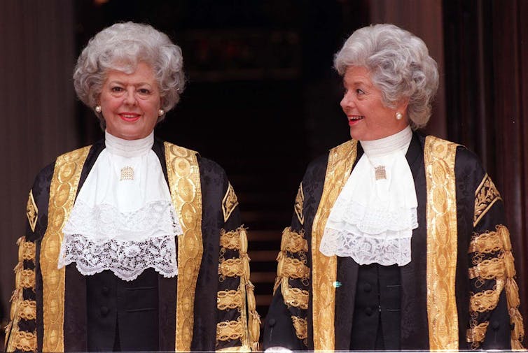 Betty Boothroyd standing next to a waxwork model of herself.