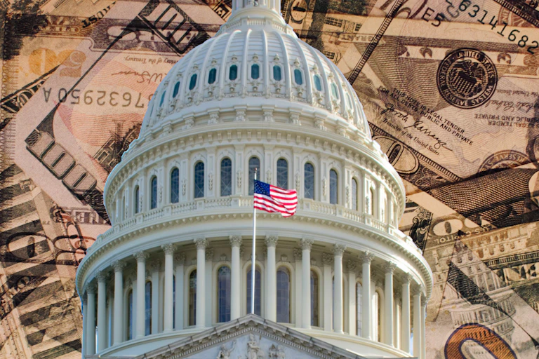 The U.S. Capitol building against the backdrop of American currency.