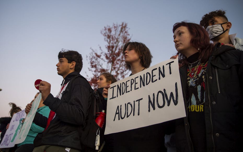 Students seen holding signs.