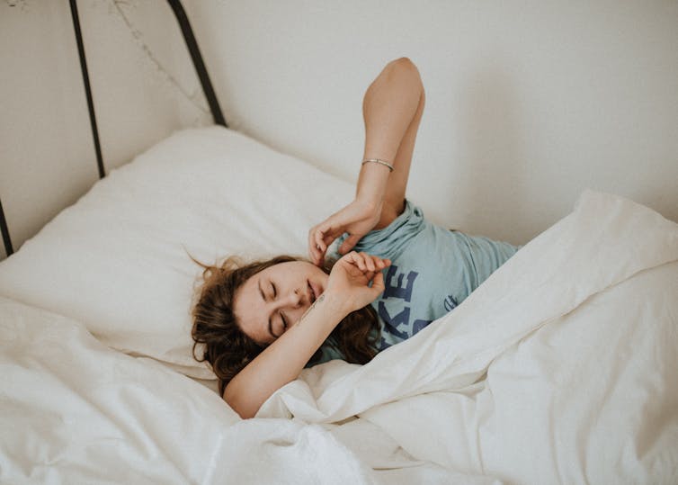 Woman wakes up, tired