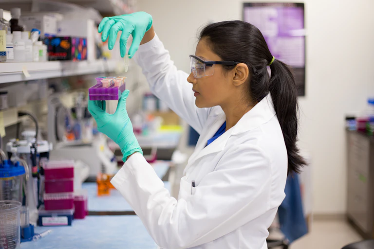 Scientist holds small tubes