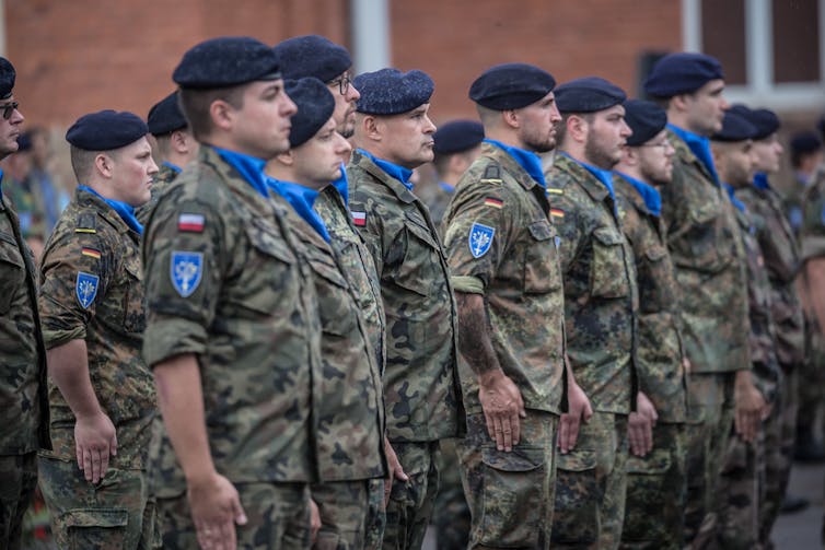 A group of soldiers stands at attention.