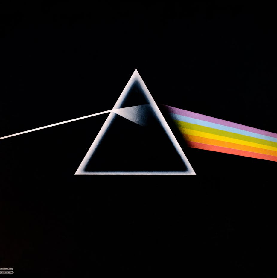 A black square album cover with a triangle prism showing refraction of a rainbow of light.