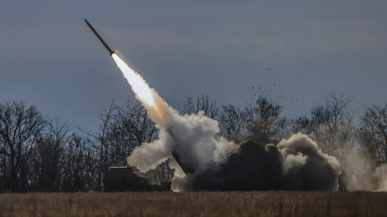 A missile launches from a field