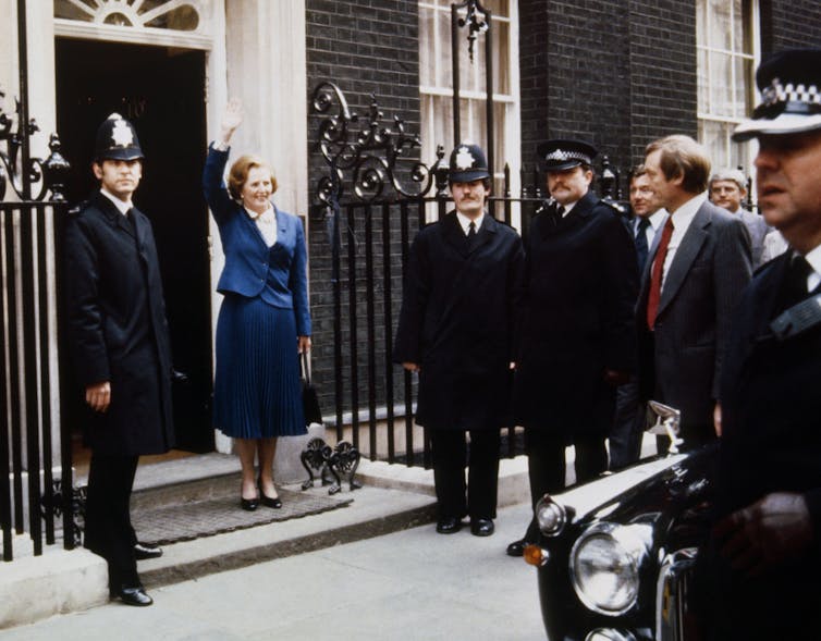 Margaret Thatcher waving outside 10 Downing Street.