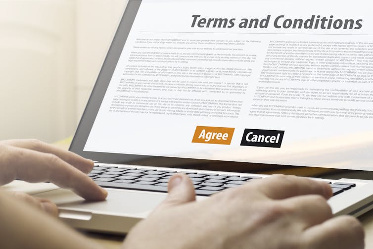 A laptop showing a terms and conditions document.