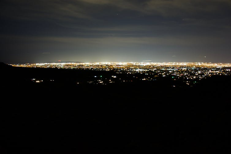 The light pollution of a large city against the night sky.
