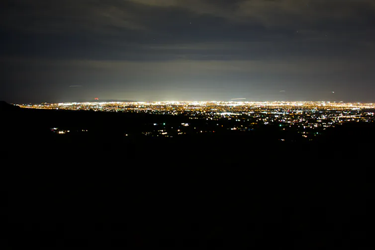 The light pollution of a large city against the night sky.