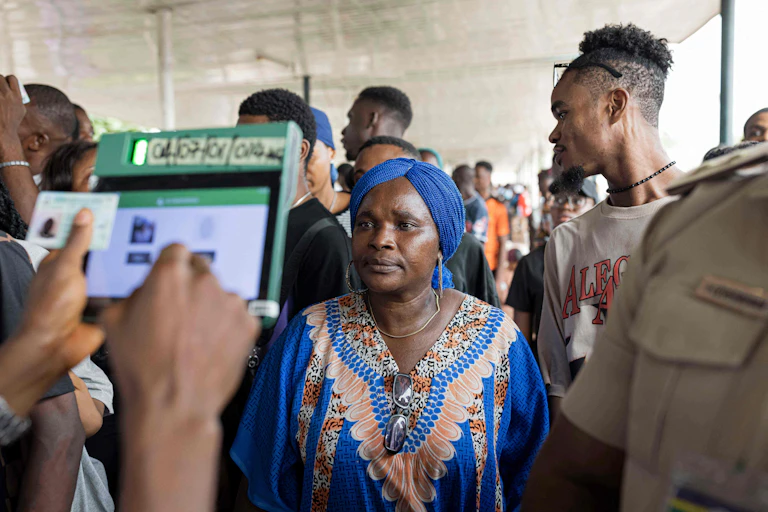 A woman stands in front of a machine