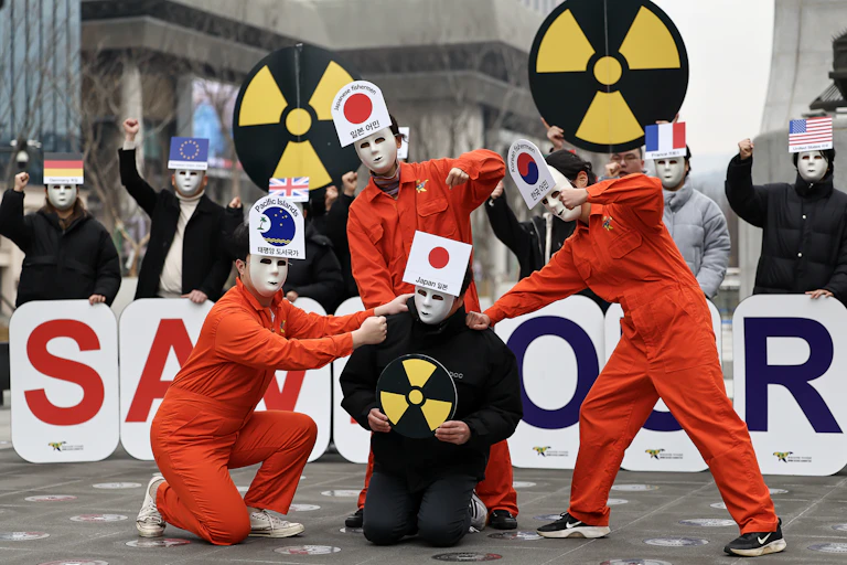 Environmental activists give a performance calling for Japan to call off its decision to release radioactive water from the crippled Fukushima nuclear power station into the ocean during a rally in Seoul, South Korea, 28 February 2023.