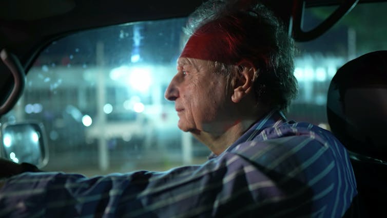 Older man driving at night