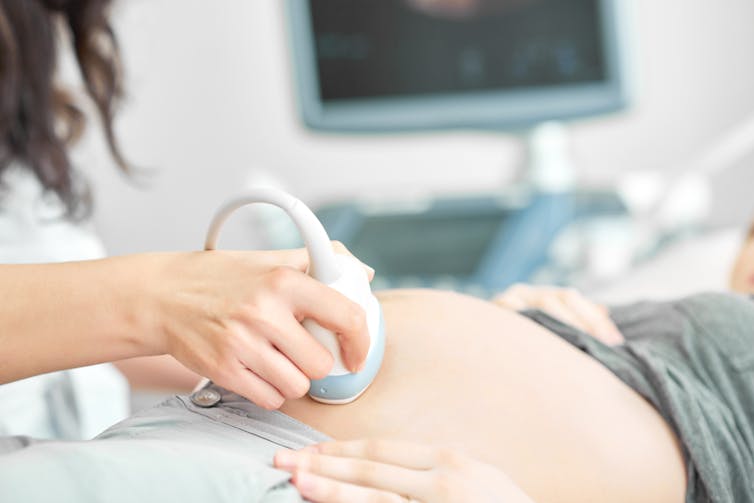 Sonographer persons pregnancy ultrasound