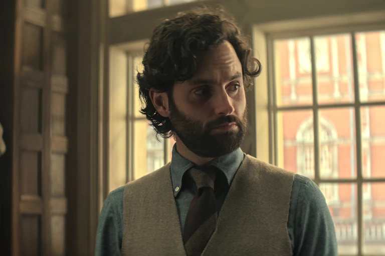 Joe Goldberg in a university room wearing a waistcoat and shirt.