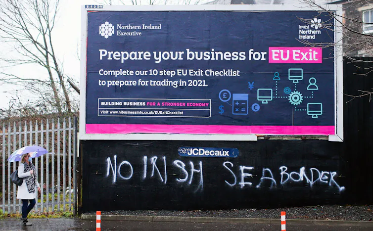 A billboard add saying 'Prepare your business for EU exit' with graffiti saying 'No Irish Sea border'.