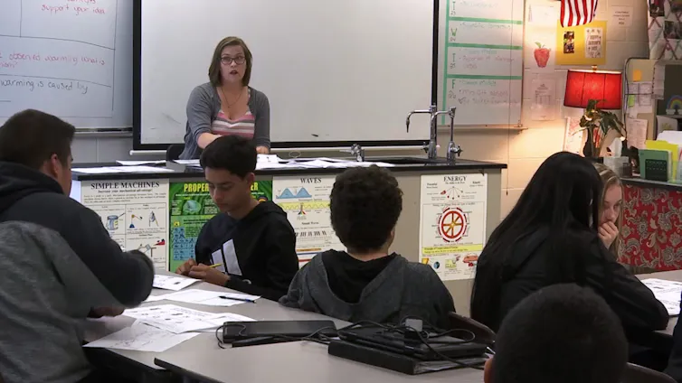 A teacher seen in a classroom.