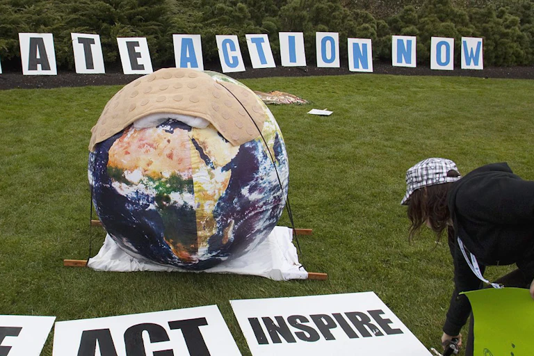 A person seen bending over signs that say see, act, inspire