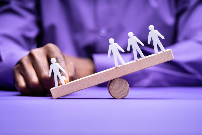 Illustrative image of figurines out of balance.