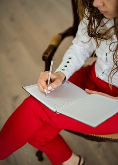 Woman writing in notebook
