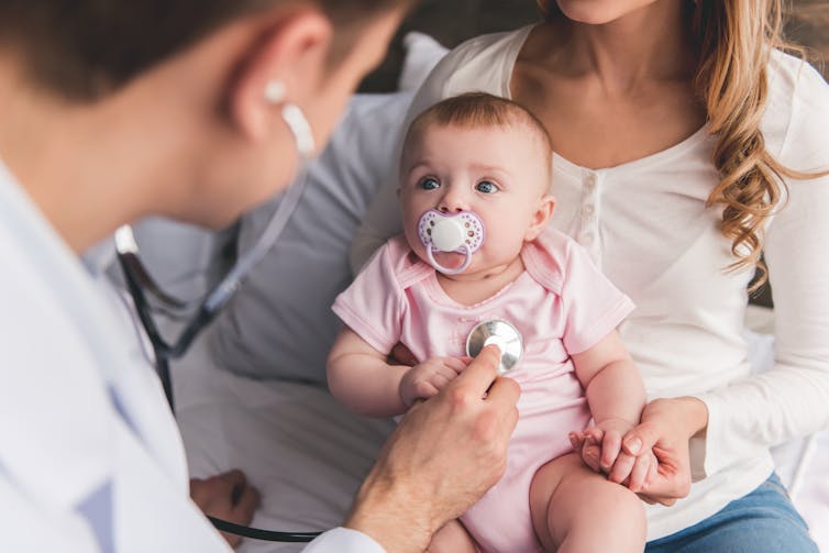 Doctor listening to baby's chest