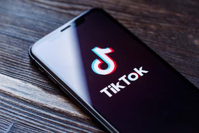 A phone displaying the TikTok app loadings screen