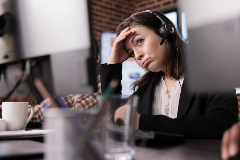 Young woman wearing a headset looking tired