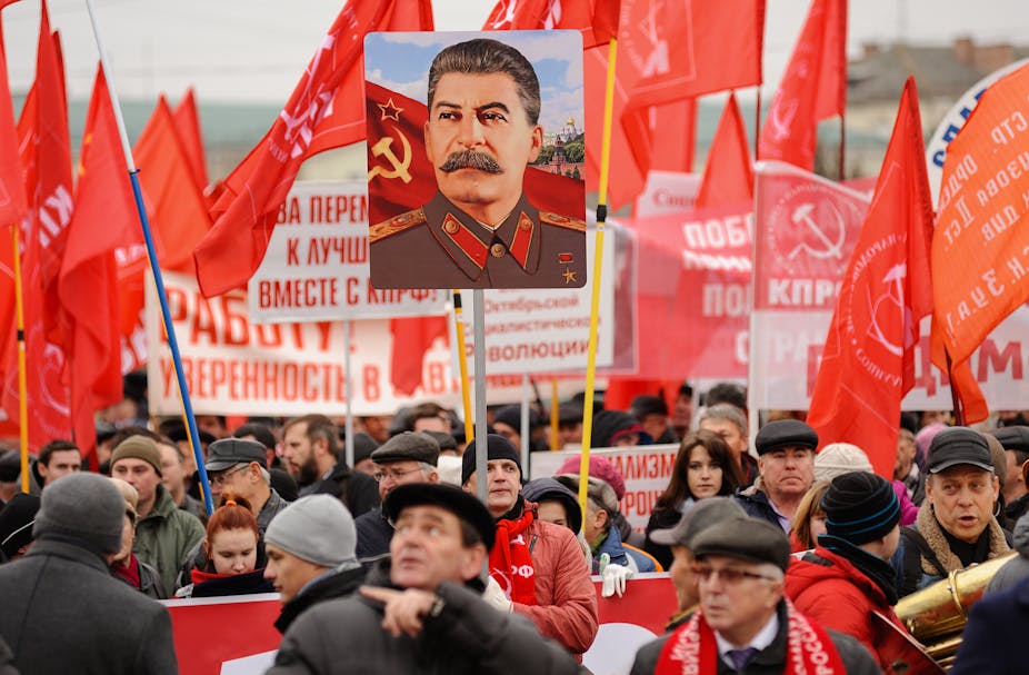 In Russia, a portrait of Staline emerges out of a communist gathering 